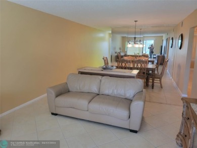 ELEGANT, IMMACULATE AND SPACIOUS UNIT WITH SERENE VIEWS OF GOLF on Wynmoor Golf Course in Florida - for sale on GolfHomes.com, golf home, golf lot