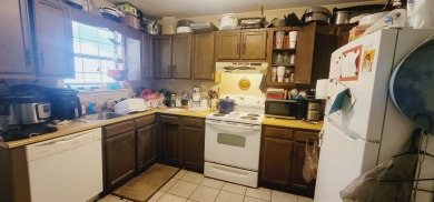 LOVELY Occupied SE Duplex w/ Carports, Fenced Yards, & Storage on Hilaman Park Golf Course in Florida - for sale on GolfHomes.com, golf home, golf lot