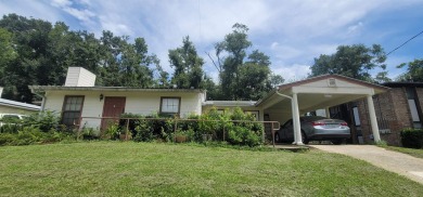 LOVELY Occupied SE Duplex w/ Carports, Fenced Yards, & Storage on Hilaman Park Golf Course in Florida - for sale on GolfHomes.com, golf home, golf lot