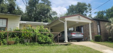 LOVELY Occupied SE Duplex w/ Carports, Fenced Yards, & Storage on Hilaman Park Golf Course in Florida - for sale on GolfHomes.com, golf home, golf lot