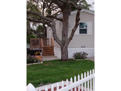 This charming 2022 Factory Expo Direct Park Model sits on one of on Glen Lakes Country Club in Florida - for sale on GolfHomes.com, golf home, golf lot