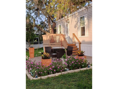 This charming 2022 Factory Expo Direct Park Model sits on one of on Glen Lakes Country Club in Florida - for sale on GolfHomes.com, golf home, golf lot