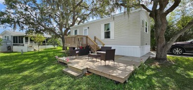 This charming 2022 Factory Expo Direct Park Model sits on one of on Glen Lakes Country Club in Florida - for sale on GolfHomes.com, golf home, golf lot
