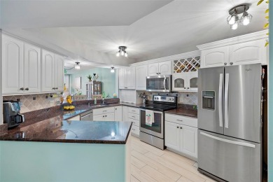 This beautifully updated 2-bedroom plus den residence in the on Isla Del Sol Yacht and Country Club in Florida - for sale on GolfHomes.com, golf home, golf lot