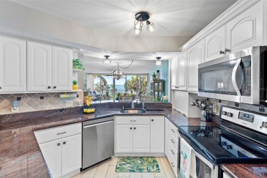 This beautifully updated 2-bedroom plus den residence in the on Isla Del Sol Yacht and Country Club in Florida - for sale on GolfHomes.com, golf home, golf lot