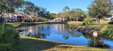 Beautiful end unit condo, located on tranquil pond with serene on Tarpon Woods Golf Club in Florida - for sale on GolfHomes.com, golf home, golf lot