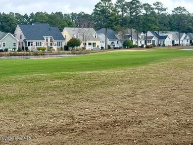 This lovely, large, wooded lot overlooks the 4th fairway and on Carolina National Golf Club in North Carolina - for sale on GolfHomes.com, golf home, golf lot