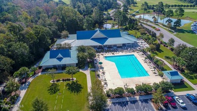 This lovely, large, wooded lot overlooks the 4th fairway and on Carolina National Golf Club in North Carolina - for sale on GolfHomes.com, golf home, golf lot