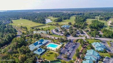 This lovely, large, wooded lot overlooks the 4th fairway and on Carolina National Golf Club in North Carolina - for sale on GolfHomes.com, golf home, golf lot