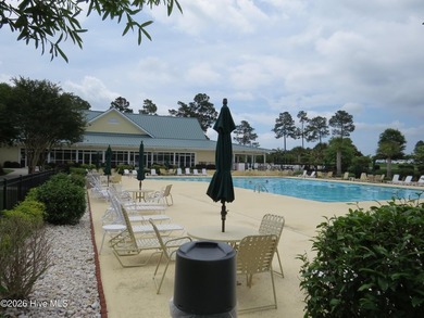 This lovely, large, wooded lot overlooks the 4th fairway and on Carolina National Golf Club in North Carolina - for sale on GolfHomes.com, golf home, golf lot