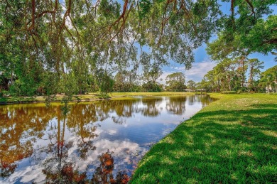 Indulge in unparalleled views of the tranquil lake and verdant on Calusa Lakes Golf Club in Florida - for sale on GolfHomes.com, golf home, golf lot