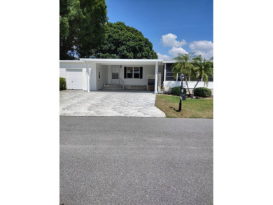 Tremendous 3-bedroom 2-bath located on the 9th fairway at Four on Four Lakes Golf Club in Florida - for sale on GolfHomes.com, golf home, golf lot