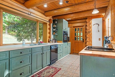 Welcome to this stunning Up North luxury log home perfectly on Boyne Mountain Resort - Monument Course in Michigan - for sale on GolfHomes.com, golf home, golf lot