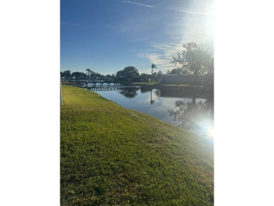 Do you enjoy a beautiful water view with the sun bouncing off on Golden Lakes Golf Course in Florida - for sale on GolfHomes.com, golf home, golf lot