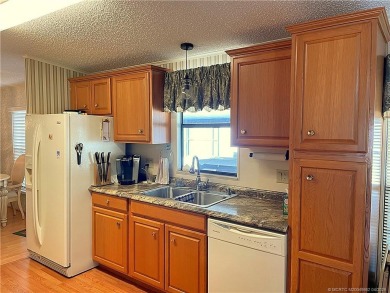 Delightful furnished home featuring wood laminate flooring on Indianwood Golf and Country Club in Florida - for sale on GolfHomes.com, golf home, golf lot
