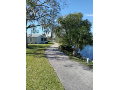 Beautiful cozy waterfront home in Village green Community.  This on Vista Plantation Golf Club in Florida - for sale on GolfHomes.com, golf home, golf lot