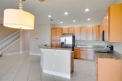 This Eagle Creek townhouse with an upstairs balcony overlooking on Eagle Creek Golf Club in Florida - for sale on GolfHomes.com, golf home, golf lot