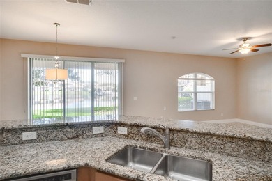 This Eagle Creek townhouse with an upstairs balcony overlooking on Eagle Creek Golf Club in Florida - for sale on GolfHomes.com, golf home, golf lot