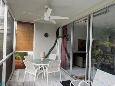 Convenient first floor unit condo in the tropical Palm Aire on Palm-Aire Country Club and Resort - The Oaks in Florida - for sale on GolfHomes.com, golf home, golf lot