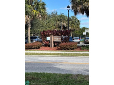 Convenient first floor unit condo in the tropical Palm Aire on Palm-Aire Country Club and Resort - The Oaks in Florida - for sale on GolfHomes.com, golf home, golf lot
