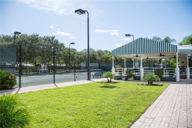 Lovely bright light waterfront villa, with enclosed porch plus on Oak Harbor Country Club in Florida - for sale on GolfHomes.com, golf home, golf lot