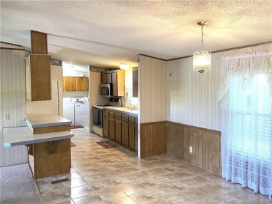 This 3 bedroom, 2 bathroom ranch home is priced to sell. It is on Linn Valley Lakes - Deer Trace Golf Course in Kansas - for sale on GolfHomes.com, golf home, golf lot