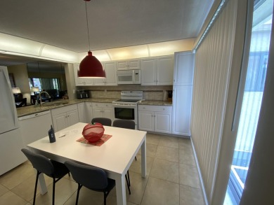 Beautiful unit with relaxing view from screen porch ready for on Indian Spring Golf and Country Club in Florida - for sale on GolfHomes.com, golf home, golf lot