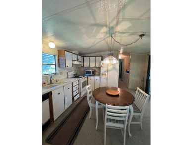 Cozy furnished home with no rear neighbors, ready for you to on Lake Henry Golf Club in Florida - for sale on GolfHomes.com, golf home, golf lot