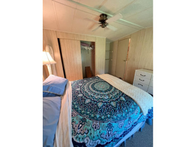 Cozy furnished home with no rear neighbors, ready for you to on Lake Henry Golf Club in Florida - for sale on GolfHomes.com, golf home, golf lot