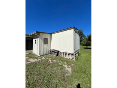 Cozy furnished home with no rear neighbors, ready for you to on Lake Henry Golf Club in Florida - for sale on GolfHomes.com, golf home, golf lot