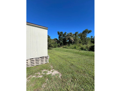 Cozy furnished home with no rear neighbors, ready for you to on Lake Henry Golf Club in Florida - for sale on GolfHomes.com, golf home, golf lot