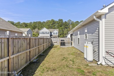 Charming 4-Bedroom Home with Solar Power on a Corner Lot in on Magnolia Greens Golf Plantation in North Carolina - for sale on GolfHomes.com, golf home, golf lot