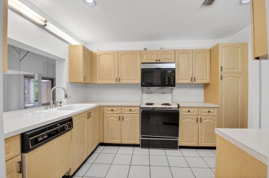 Nestled within a gated community, this 3 bedroom 2.5 bath on Boca Delray Golf and Country Club in Florida - for sale on GolfHomes.com, golf home, golf lot
