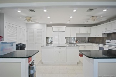 Enjoy first floor living with fantastic views from every room on Martin County Golf Course in Florida - for sale on GolfHomes.com, golf home, golf lot