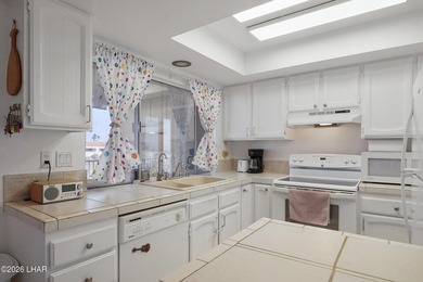 Elevate your lifestyle with sweeping water views and a front-row on London Bridge Golf Course in Arizona - for sale on GolfHomes.com, golf home, golf lot