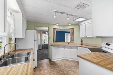 Well-maintained 2-bedroom, 2-bath manufactured home located in on Zellwood Station Country Club in Florida - for sale on GolfHomes.com, golf home, golf lot