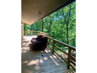 This 2-bedroom, 1-bath home has two lots totalling .75-acre lot on Bella Vista - Metfield Golf Complex and Country Club in Arkansas - for sale on GolfHomes.com, golf home, golf lot