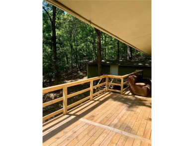 This 2-bedroom, 1-bath home has two lots totalling .75-acre lot on Bella Vista - Metfield Golf Complex and Country Club in Arkansas - for sale on GolfHomes.com, golf home, golf lot