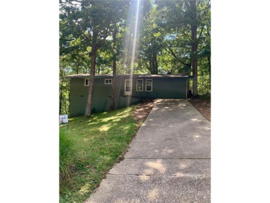 This 2-bedroom, 1-bath home has two lots totalling .75-acre lot on Bella Vista - Metfield Golf Complex and Country Club in Arkansas - for sale on GolfHomes.com, golf home, golf lot