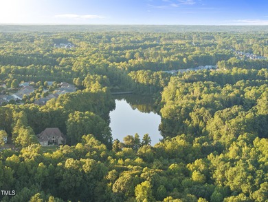 Welcome to an extraordinary home tucked away on a quiet on Hasentree Club in North Carolina - for sale on GolfHomes.com, golf home, golf lot