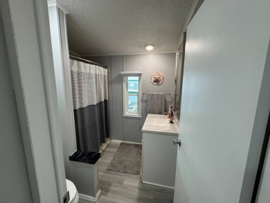 ***JUST REDUCED***This 2/2 1045 sq ft home is beautifully on Lake Henry Golf Club in Florida - for sale on GolfHomes.com, golf home, golf lot
