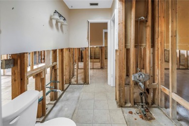 This well maintained concrete block corner home sustained flood on Mangrove Bay Golf Course in Florida - for sale on GolfHomes.com, golf home, golf lot