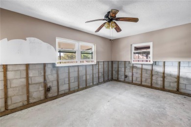 This well maintained concrete block corner home sustained flood on Mangrove Bay Golf Course in Florida - for sale on GolfHomes.com, golf home, golf lot