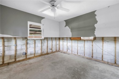 This well maintained concrete block corner home sustained flood on Mangrove Bay Golf Course in Florida - for sale on GolfHomes.com, golf home, golf lot