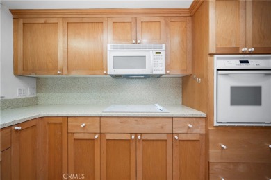 Step into this beautifully reimagined upstairs corner unit in on Leisure World Seal Beach Golf Course in California - for sale on GolfHomes.com, golf home, golf lot