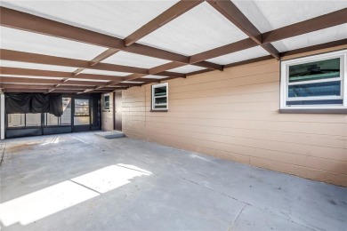 This well maintained concrete block corner home sustained flood on Mangrove Bay Golf Course in Florida - for sale on GolfHomes.com, golf home, golf lot