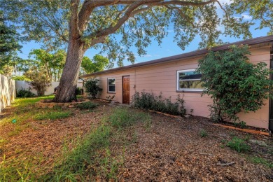 This well maintained concrete block corner home sustained flood on Mangrove Bay Golf Course in Florida - for sale on GolfHomes.com, golf home, golf lot