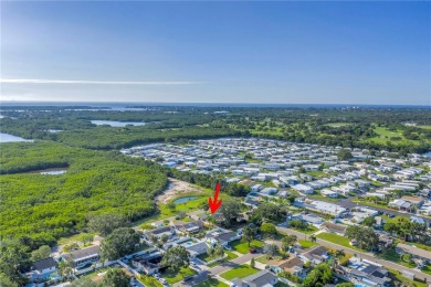 This well maintained concrete block corner home sustained flood on Mangrove Bay Golf Course in Florida - for sale on GolfHomes.com, golf home, golf lot