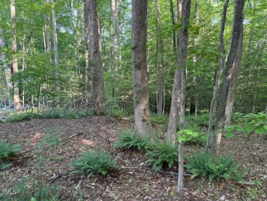 Private & wooded building lot on a quiet street of custom homes on River Golf and County Club at Lake Royale in North Carolina - for sale on GolfHomes.com, golf home, golf lot