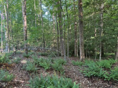 Private & wooded building lot on a quiet street of custom homes on River Golf and County Club at Lake Royale in North Carolina - for sale on GolfHomes.com, golf home, golf lot